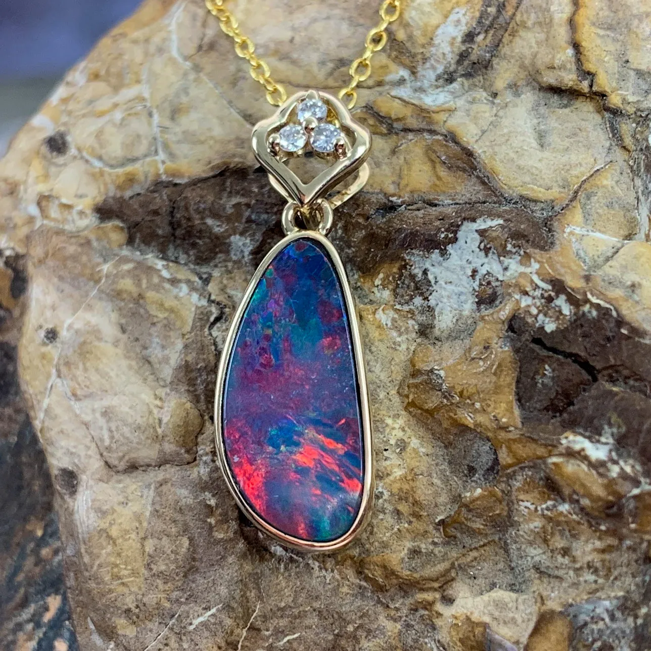 14kt Yellow Gold pendant with one Red Opal doublet and diamonds