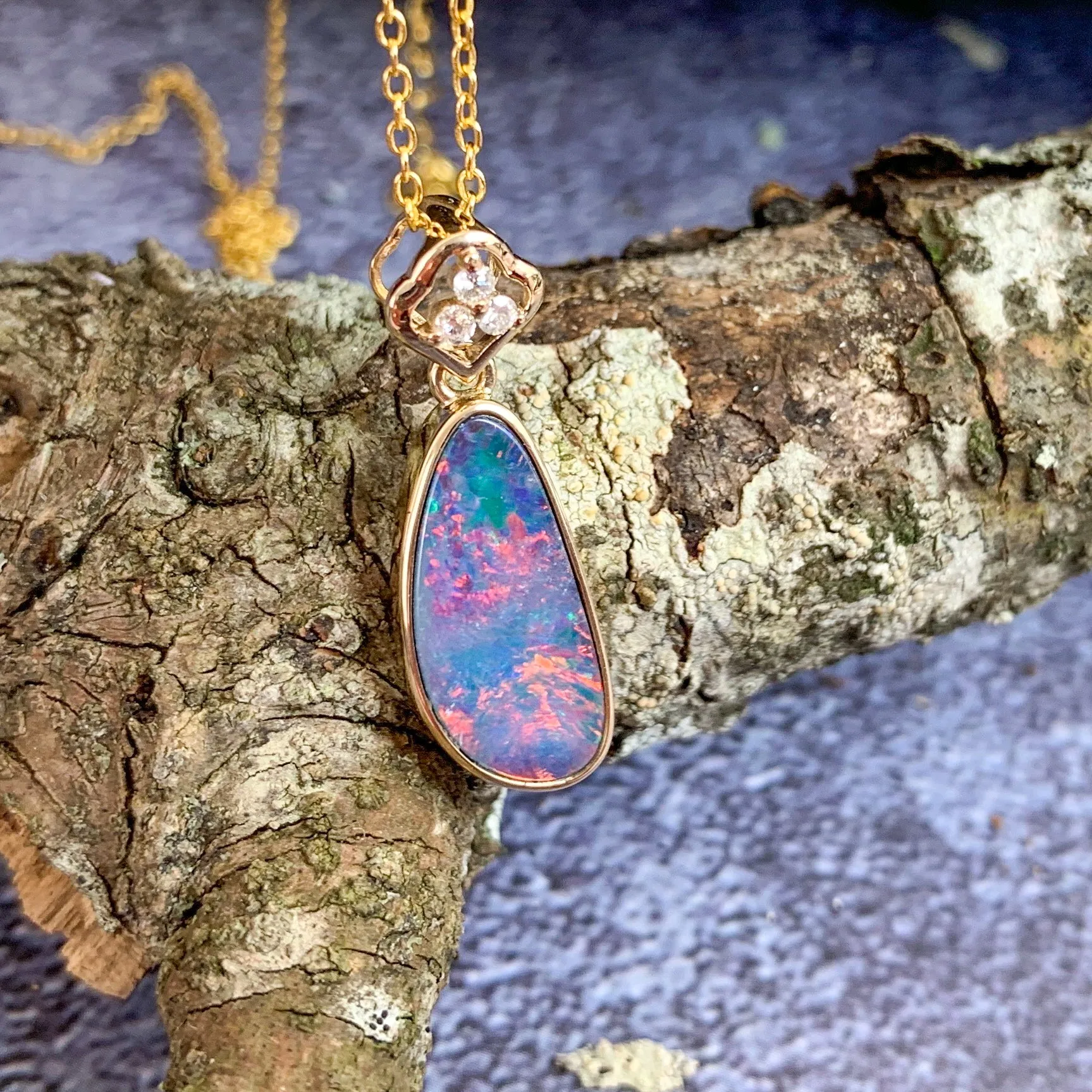 14kt Yellow Gold pendant with one Red Opal doublet and diamonds